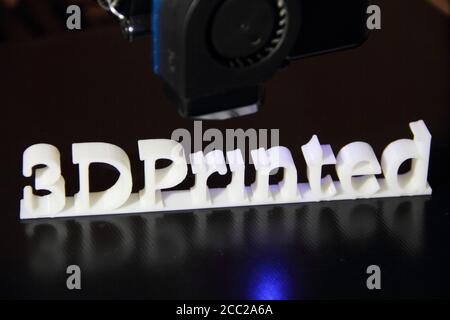 a 3D printer printing the text "3d printed" Stock Photo