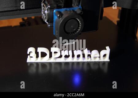 a 3D printer printing the text "3d printed" Stock Photo