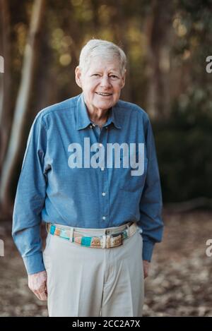 Portrait of Senior Adult Male Smiling in Forest Stock Photo