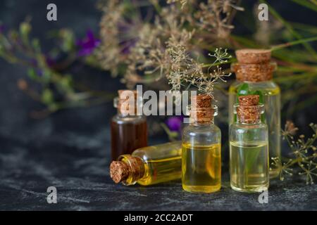 Herbal essential oils in glass bottles. Aromatherapy, spa, massage, skin care and alternative medicine concept Stock Photo