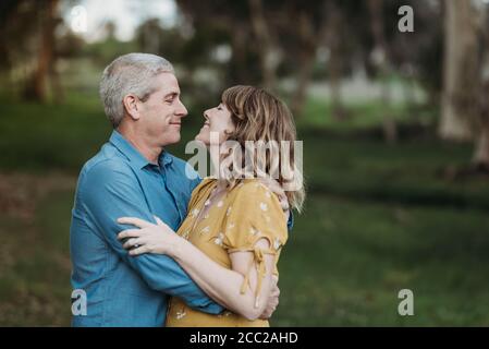Portrait of married couple closely embracing and looking at each other Stock Photo