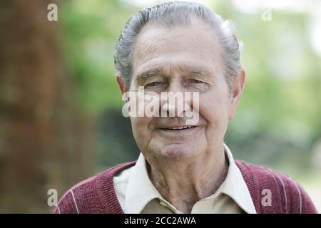 Germany, Cologne, Portrait of senior man in park, close up Stock Photo