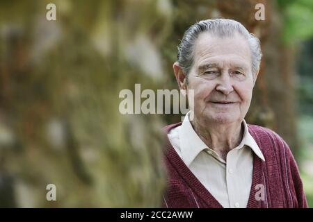 Germany, Cologne, Portrait of senior man in park, close up Stock Photo