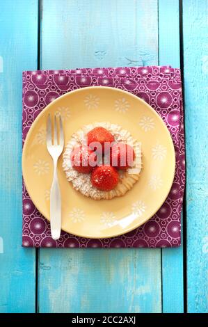 Strawberry tartlet in plate, close up Stock Photo