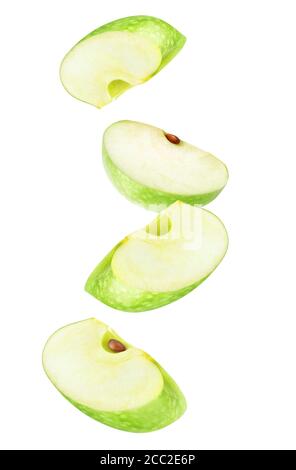 Isolated apple wedges in the air. Four falling pieces of green apple fruit isolated on white background Stock Photo