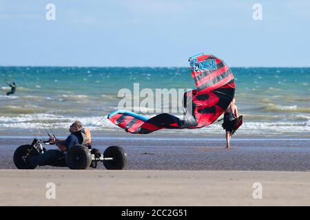 Camber, East Sussex, UK. 17 Aug, 2020. UK Weather: The wind has picked up which is Ideal for these kite surfers who take advantage of the blustery conditions at Camber in East Sussex. Photo Credit: Paul Lawrenson-PAL Media/Alamy Live News Stock Photo