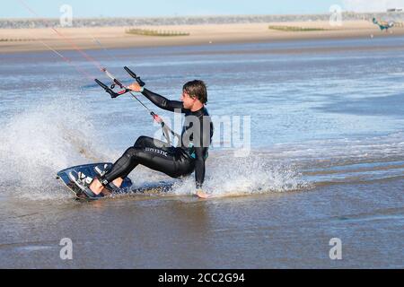 Camber, East Sussex, UK. 17 Aug, 2020. UK Weather: The wind has picked up which is Ideal for these kite surfers who take advantage of the blustery conditions at Camber in East Sussex. Photo Credit: Paul Lawrenson-PAL Media/Alamy Live News Stock Photo