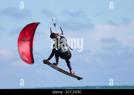 Camber, East Sussex, UK. 17 Aug, 2020. UK Weather: The wind has picked up which is Ideal for these kite surfers who take advantage of the blustery conditions at Camber in East Sussex. Photo Credit: Paul Lawrenson-PAL Media/Alamy Live News Stock Photo