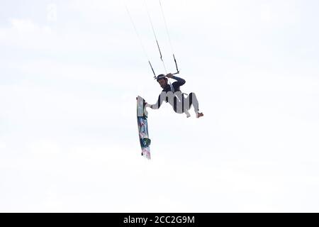 Camber, East Sussex, UK. 17 Aug, 2020. UK Weather: The wind has picked up which is Ideal for these kite surfers who take advantage of the blustery conditions at Camber in East Sussex. Photo Credit: Paul Lawrenson-PAL Media/Alamy Live News Stock Photo