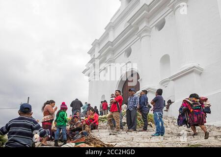 Local people called Mayan K'iche selling flowers on market day in front of the church Iglesia de Santo Tomás in Chichicastenango, El Quiché, Guatemala Stock Photo