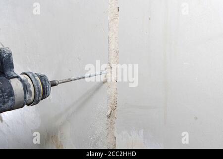 drill hole for electrical outlet outlet, special power tool drill. Stock Photo