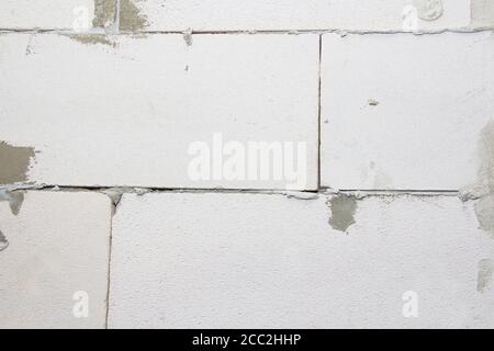A Fragment Of A Modern Wall Made Of Gas Silicate Blocks. The process of laying blocks. Stock Photo