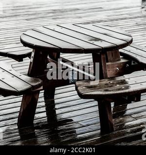Round Picnic Table And Chairs Outside In The Rain With No People Stock Photo