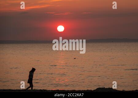 the blood red sun sets over the Baltic Sea Stock Photo