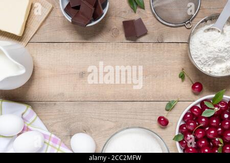 Top view raw ingredients for cooking cherry pie on wooden background with copy space. Bakery background Stock Photo
