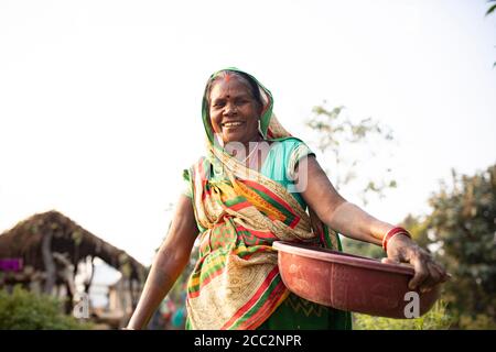 A woman farmer smiles on her small farm in the state of Bihar, India. Stock Photo