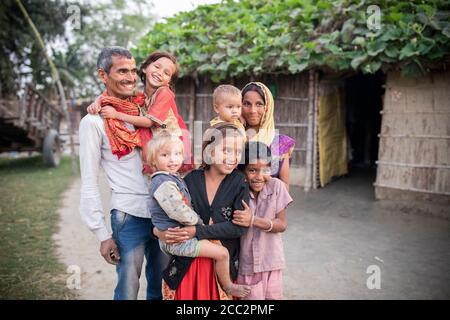 Rajendra Kushwaha (36) and his wife Nikky Devi (34) live in West Champaran District, Bihar, India with their five daughters. As part of their participation in LWR’s Transboundary Flood Resilience Project, they have learned new agricultural techniques that have allowed their family to farm off-season crops as well as new ways of diversifying their agriculture-based livelihood. Seen here standing outside their house, Rajendra and Nikky’s daughters are Madhu Kumari (10), Kushubhu Kumari (8), Annu Kumari (6), Khushi Kumari (4) and Pushpa Kumari (2).  Transboundary Flood Resilience Project December Stock Photo