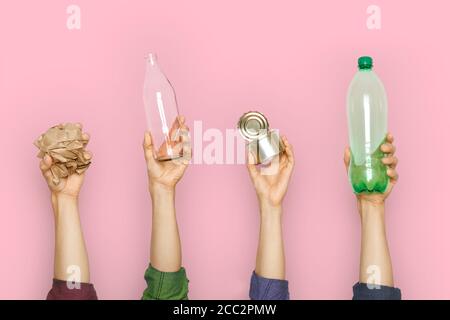 Human hands keep garbage on a pink background. Stock Photo