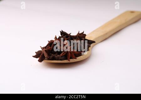 star anise in a spoon on white background. Stock Photo