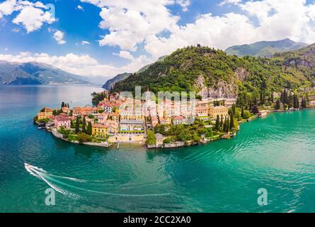 Beautifull aerial panoramic view from the drone to Varenna - famous old Italy town on bank of Como lake. High top view to Water landscape with green h