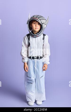 Premium Photo  Astronaut concept. portrait of little boy in cosmonaut  costume and helmet on blue background.