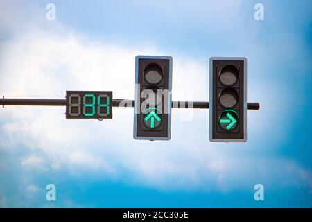 The traffic light at the intersection shows a free way. Semaphore with countdown to driving stop. Stock Photo