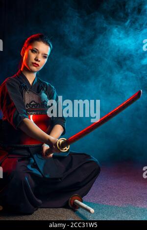 portrait of woman kendo fighter isolated. japanese martial art of sword fighting. female ready to fight. strong combat fight Stock Photo