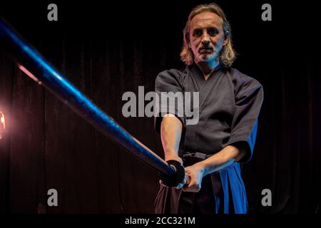 portrait of caucasian man kendo fighter with bokuto bamboo sword shinai . japanese traditional martial arts, protection, activity concept Stock Photo