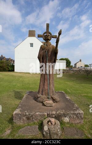 Statue of St. Aidan in grounds of St. Mary's Church, Holy Island, Northumberland, UK. Stock Photo