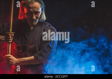 portrait of caucasian man kendo fighter with bokuto bamboo sword shinai . japanese traditional martial arts, protection, activity concept Stock Photo