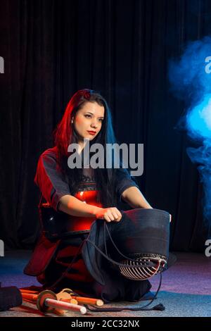 caucasian female keen on kendo activity, combining martial arts practices and values with strenuous sport-like physical activity. wearing special suit Stock Photo