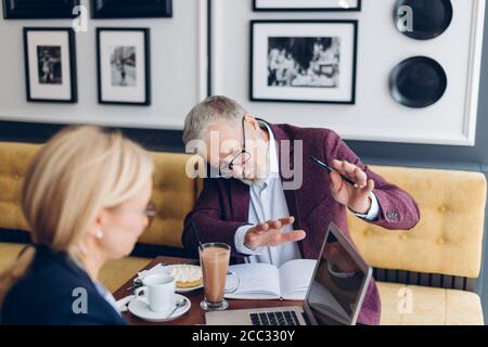 talented successful businessman is teaching a woman to work with a modern technologies. close up photo Stock Photo