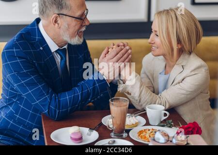mature smart couple looking at each other with care and sincere feelings. tenderness, family concepts. close up side view photo. Stock Photo