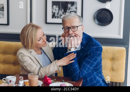 old stylish couple having serious quarrel at cafe. close up photo. woman trying to calm down her unhappy husband. lifestyle Stock Photo