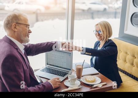 two business partners completing an agreement in the coffee shop. close up photo. trade cooperation agreement. Stock Photo