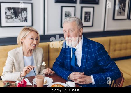 happy mature couple in fashion clothes posing to the camera at the restaurant. close up photo. friendly family spending weekend in the cafe. family tr Stock Photo