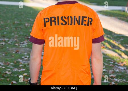 back view of american prisoner in orange clothes Stock Photo