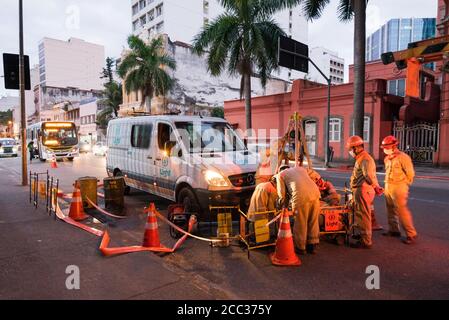 Rio de Janeiro, Brazil - July 2, 2020: Group of electrician workers are making repairs in the city street Stock Photo