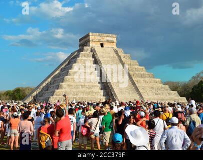 CHICHEN ITZA, MEXICO - MARCH 21,2014: Tourists watching the feathered serpent crawling down the temple (Equinox March 21 2014) Stock Photo