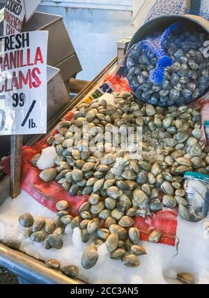 Uncooked raw manilla clams for sale at an outdoor fish market Stock Photo