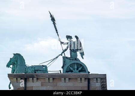 A close up view of the quadriga that stands on top of the iconic Brandenburg gate in Berlin. The statue features a goddess (Victoria) driving a four h Stock Photo