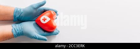 cropped view of male hands in latex gloves with red heart on white, blood donation concept Stock Photo