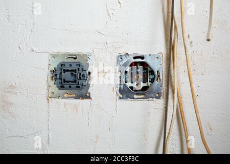Sockets when mounted without a cover. During repair. open the wires. European nest without cover isolated on a white background. Professional installa Stock Photo