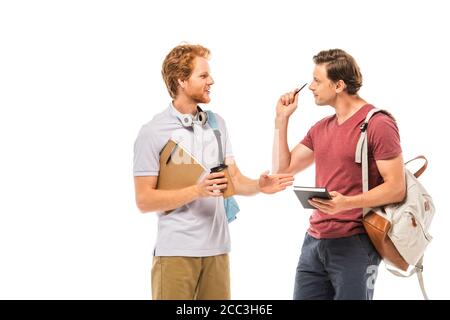 Students holding coffee to go and notebooks while talking isolated on white Stock Photo