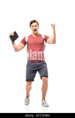Student holding notebook and showing yeah gesture on white background Stock Photo