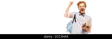 Horizontal crop of student holding notebook while showing yes gesture isolated on white Stock Photo