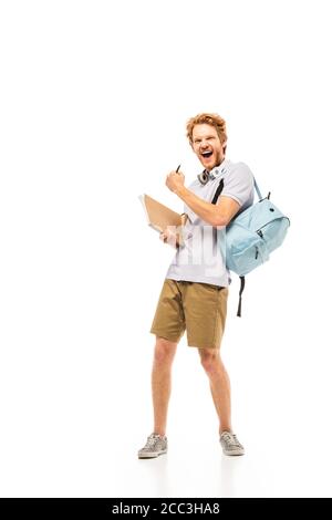 Student with backpack and notebook showing yeah gesture on white background Stock Photo