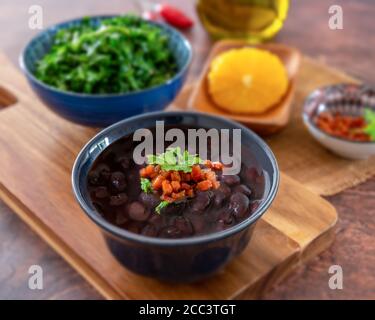 Delicious Slow Cooked Brazilian Black Beans served in a small bowl - feijao amigo Stock Photo