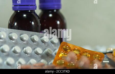 Bottles and pills. A tablet is the solid form of a medicated powder, prepared by compression, with or without added binders. Slots may be provided to Stock Photo