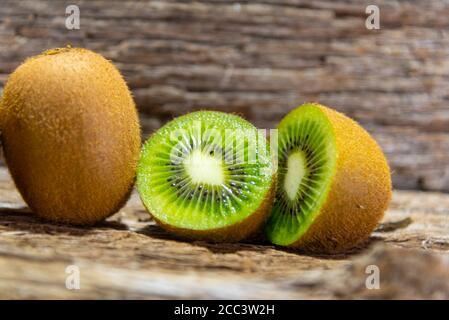 Kiwi fruits in natura and in halves. Kiwi or Kiwi (Actinidia delicious) is a fruit of the Actinidiaceae family. Its name is a tribute to the national Stock Photo